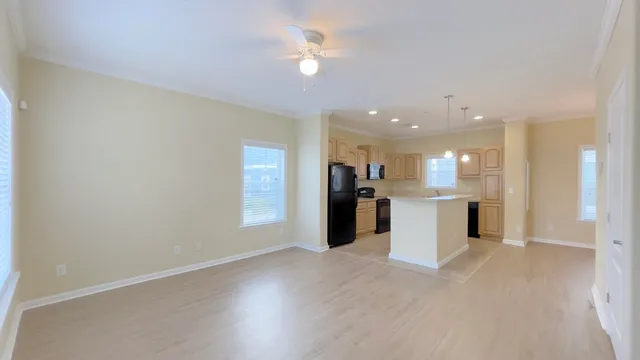 a view of a kitchen with a sink and a refrigerator
