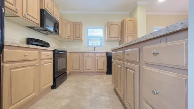 a kitchen with cabinets and stainless steel appliances