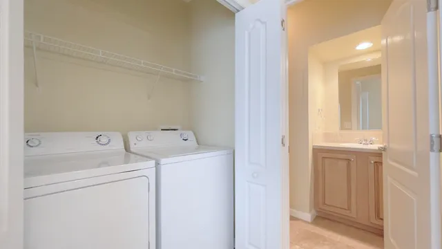 a view of storage and utility room with washer and dryer