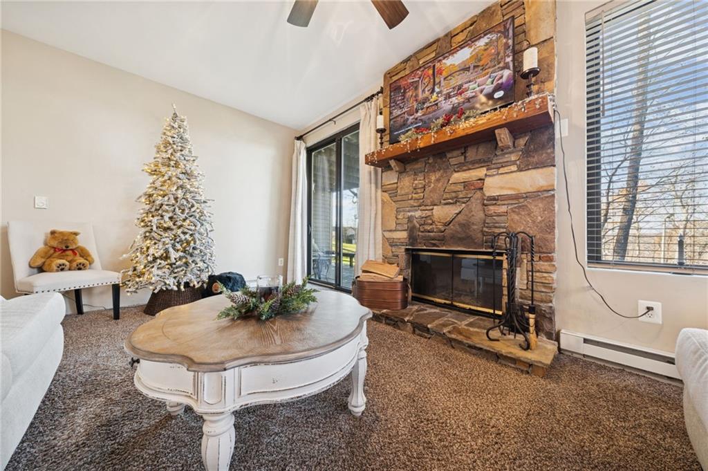 5023 Summit View Court Hidden Valley, PA 15502 - Photo 15 of 41 a living room with furniture a fireplace and a flat screen tv