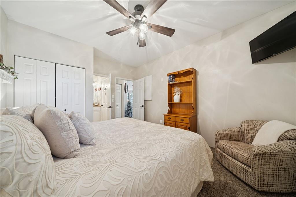 5023 Summit View Court Hidden Valley, PA 15502 - Photo 22 of 41 a bedroom with a bed a couch and a flat screen tv