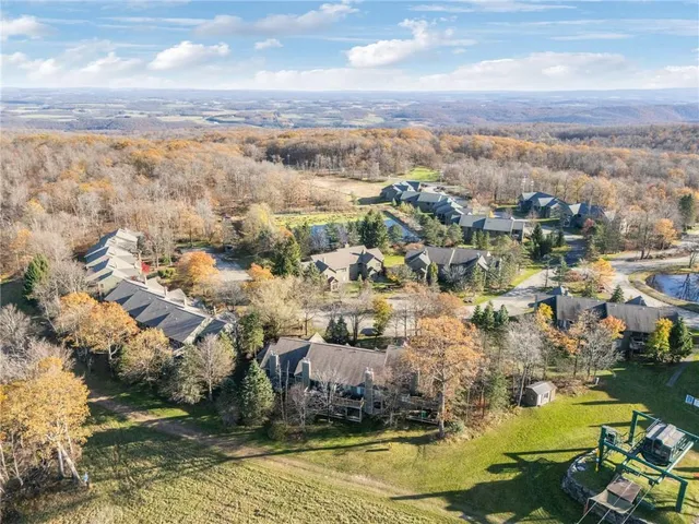 an aerial view of residential houses with outdoor space