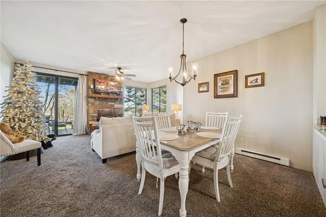 a view of a dining room with furniture and chandelier