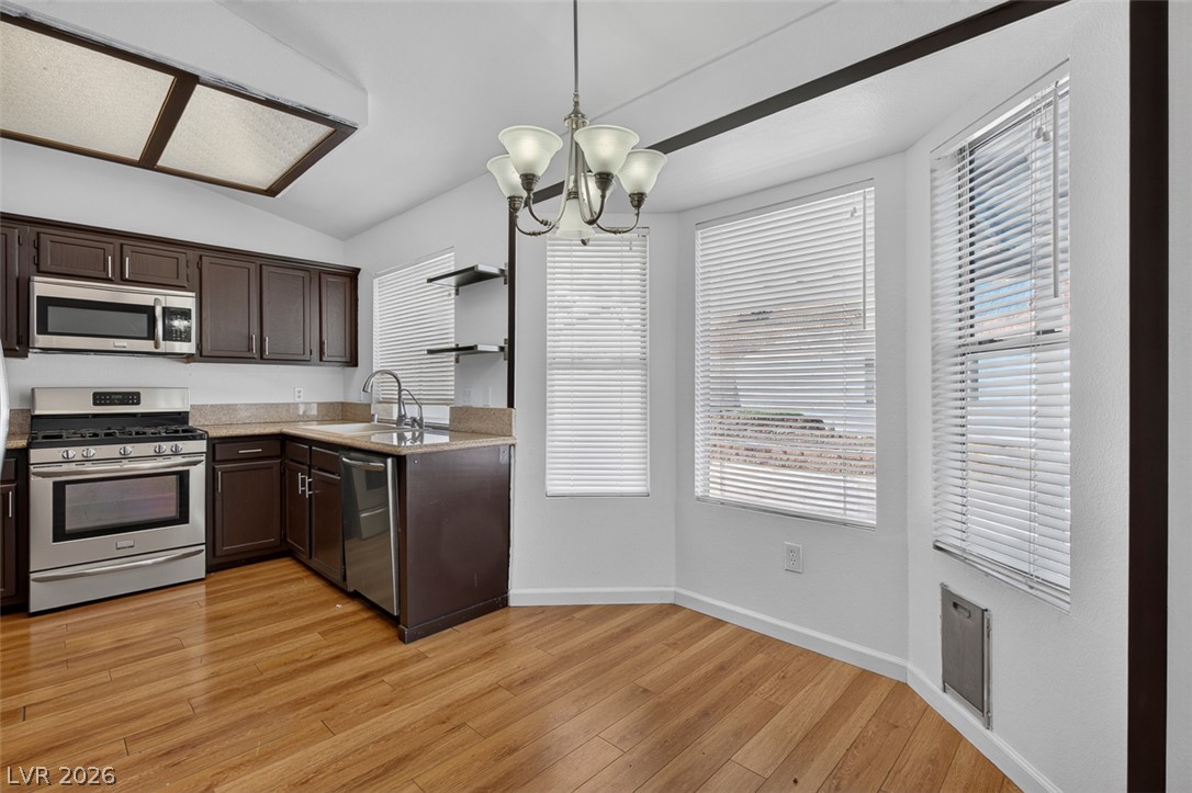 2609 Shakespeare Road Las Vegas, NV 89108 - Photo 15 of 41 A well-appointed kitchen with eat in nook- showcasing rich cabinetry and durable wood flooring.