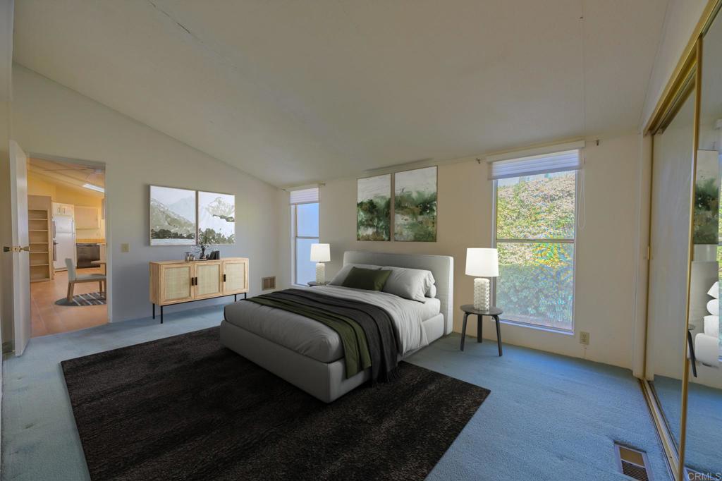 4650 Dulin Road, Unit 153 Fallbrook, CA 92003 - Photo 14 of 24 a spacious bedroom with a bed and wooden floor