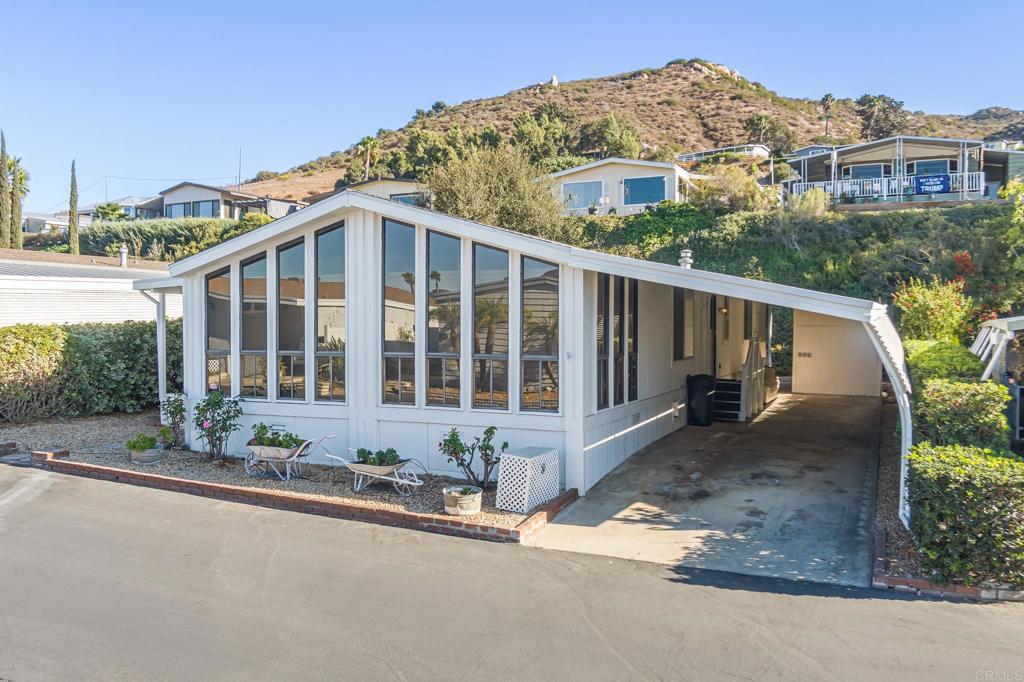 4650 Dulin Road, Unit 153 Fallbrook, CA 92003 - Photo 2 of 24 a front view of a house with a yard