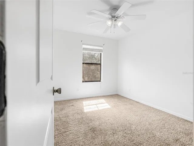 a view of room with a ceiling fan and window