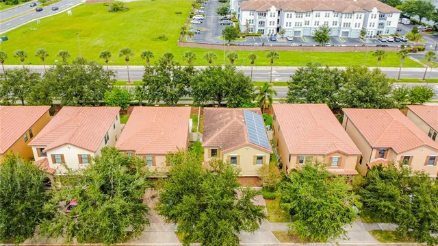 an aerial view of a house with a garden and lake view