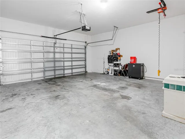 a backyard of a house with plants and large trees