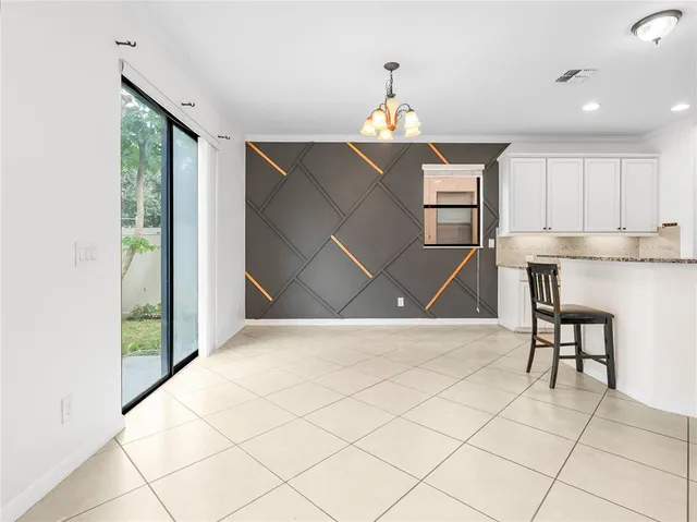 a kitchen with stainless steel appliances granite countertop a stove top oven a sink dishwasher and a refrigerator with wooden cabinets