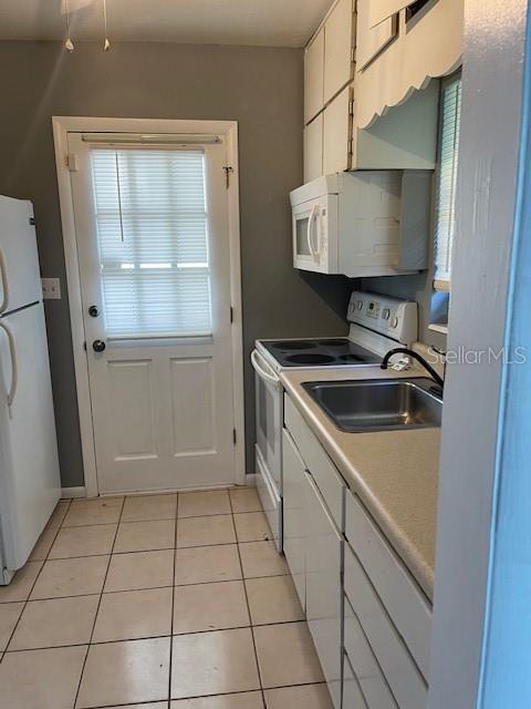 2501 Sheridan Road Mount Dora, FL 32757 - Photo 11 of 33 a kitchen with a sink and cabinets