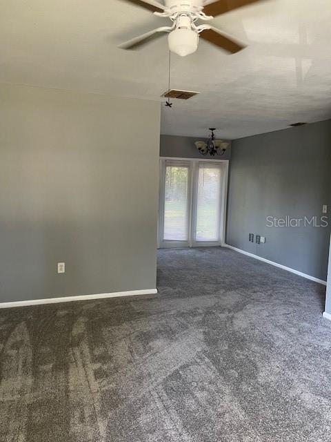 2501 Sheridan Road Mount Dora, FL 32757 - Photo 18 of 33 en empty room with windows and fan