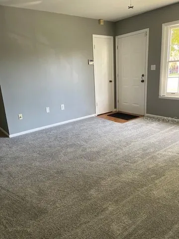 an empty room with windows and closet