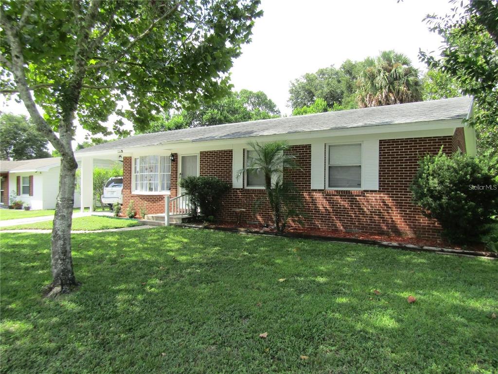 2501 Sheridan Road Mount Dora, FL 32757 - Photo 2 of 33 a view of a house with a yard and a garden