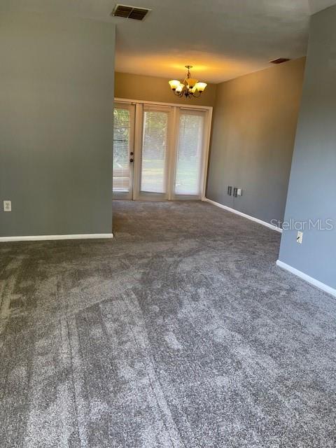 2501 Sheridan Road Mount Dora, FL 32757 - Photo 21 of 33 a view of an empty room with window and chandelier fan