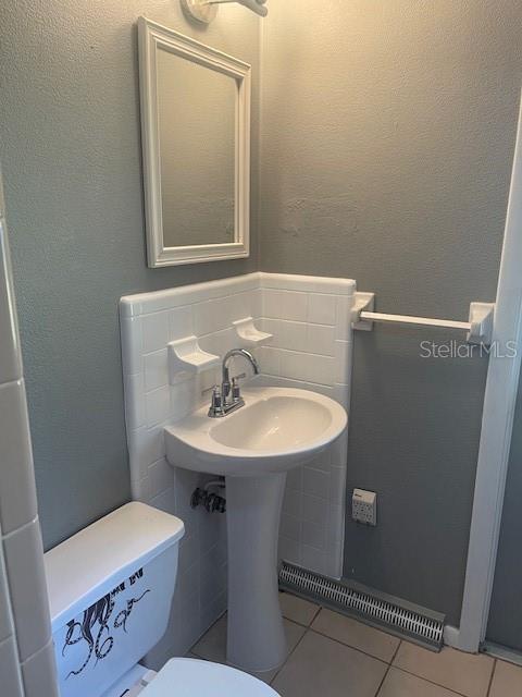 2501 Sheridan Road Mount Dora, FL 32757 - Photo 25 of 33 a bathroom with a sink a toilet and a mirror