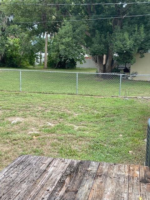 2501 Sheridan Road Mount Dora, FL 32757 - Photo 28 of 33 a view of a green field with wooden fence