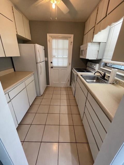 2501 Sheridan Road Mount Dora, FL 32757 - Photo 9 of 33 a kitchen with a sink a stove and cabinets