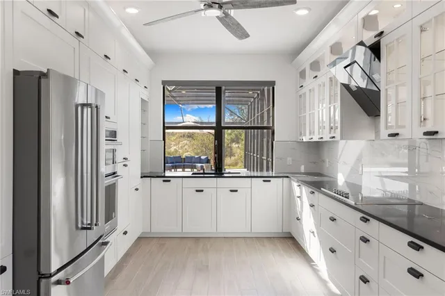 a kitchen with stainless steel appliances granite countertop a refrigerator and a sink