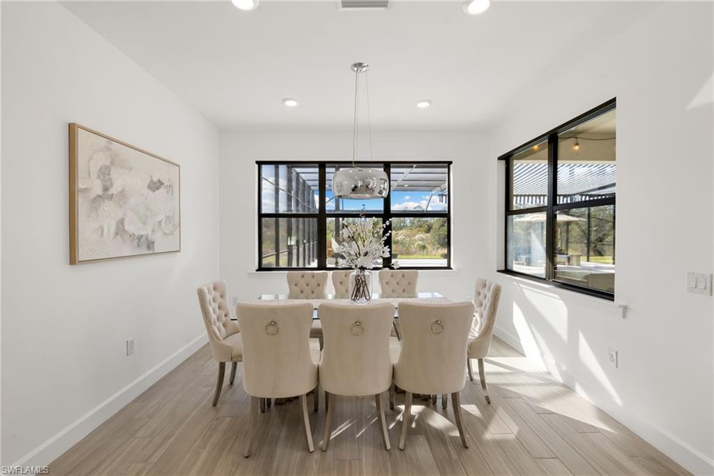19824 Beverly Park Road Estero, FL 33928 - Photo 12 of 50 a view of a dining room with furniture window and wooden floor