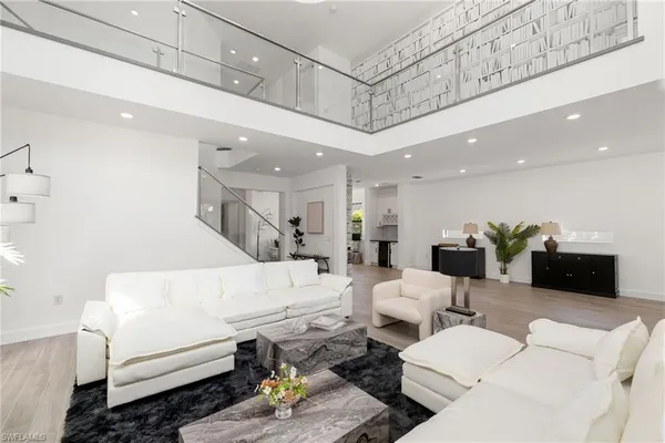 a kitchen with stainless steel appliances white cabinets and a wooden floor