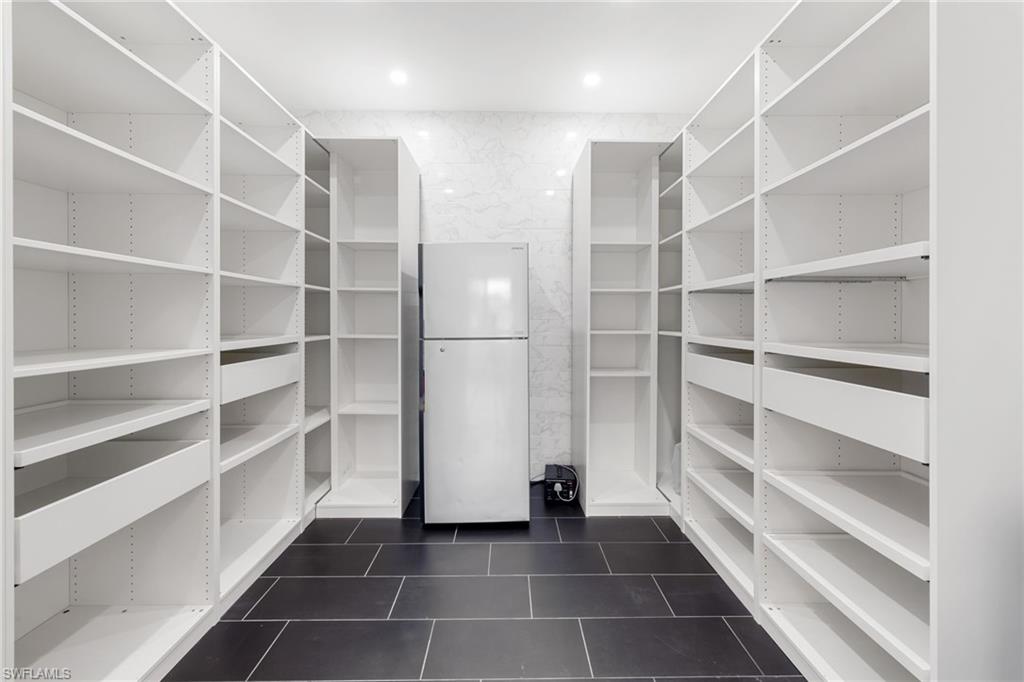 19824 Beverly Park Road Estero, FL 33928 - Photo 21 of 50 a view of walk in closet with empty racks