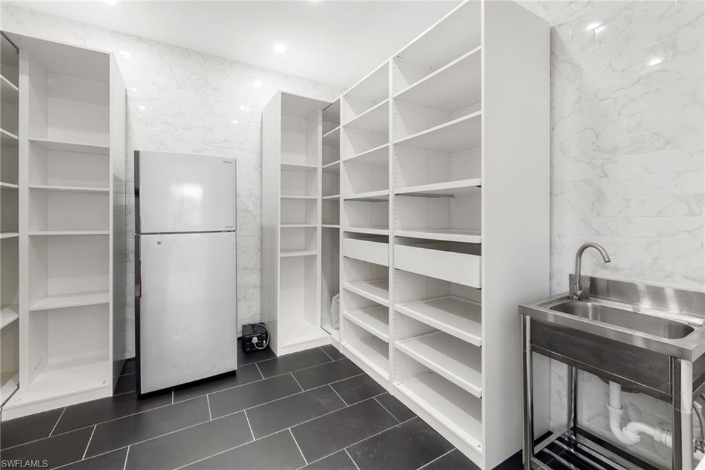 19824 Beverly Park Road Estero, FL 33928 - Photo 22 of 50 a view of a storage & utility room with empty racks