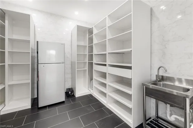 a bathroom with a bathtub a double vanity sink and a mirror
