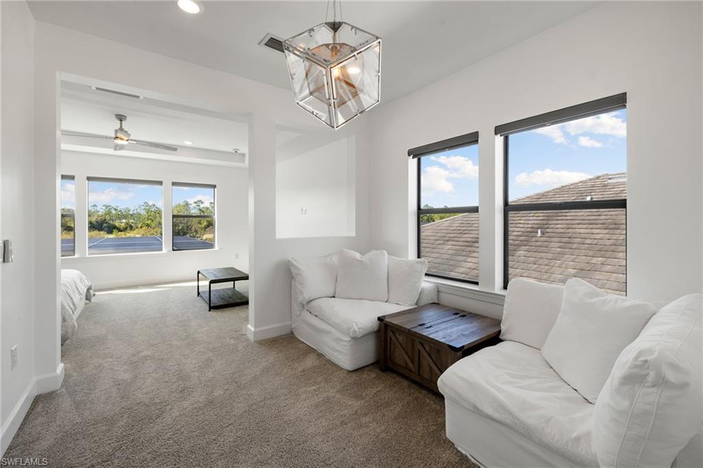 19824 Beverly Park Road Estero, FL 33928 - Photo 23 of 50 a living room with furniture and a large window