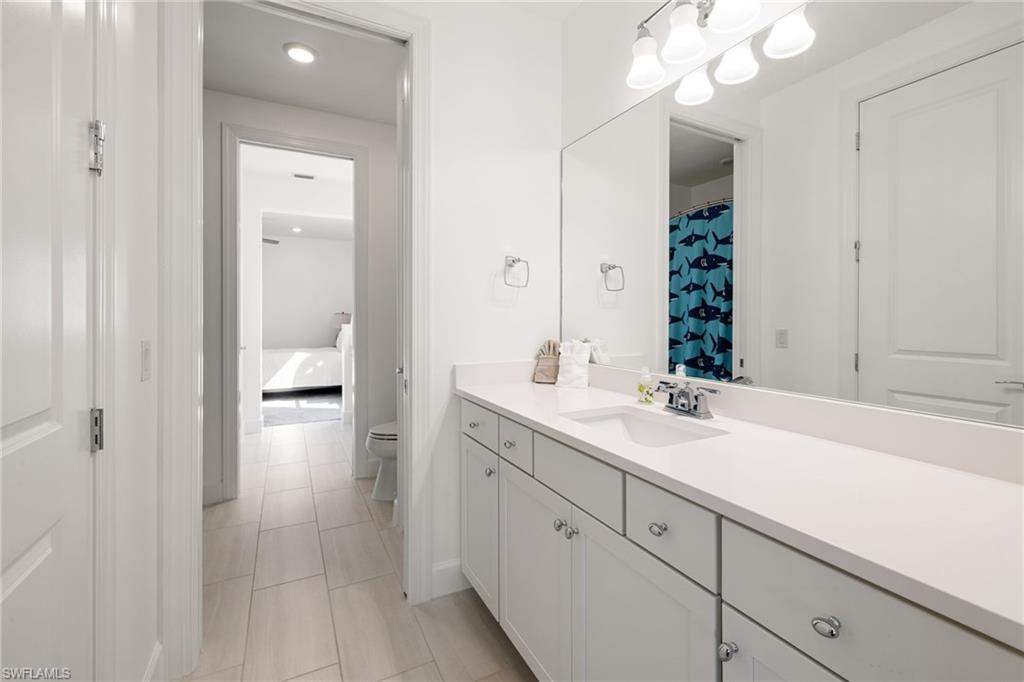 19824 Beverly Park Road Estero, FL 33928 - Photo 31 of 50 a en suite bathroom with a sink and a mirror