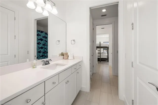 a en suite bathroom with a sink and a mirror