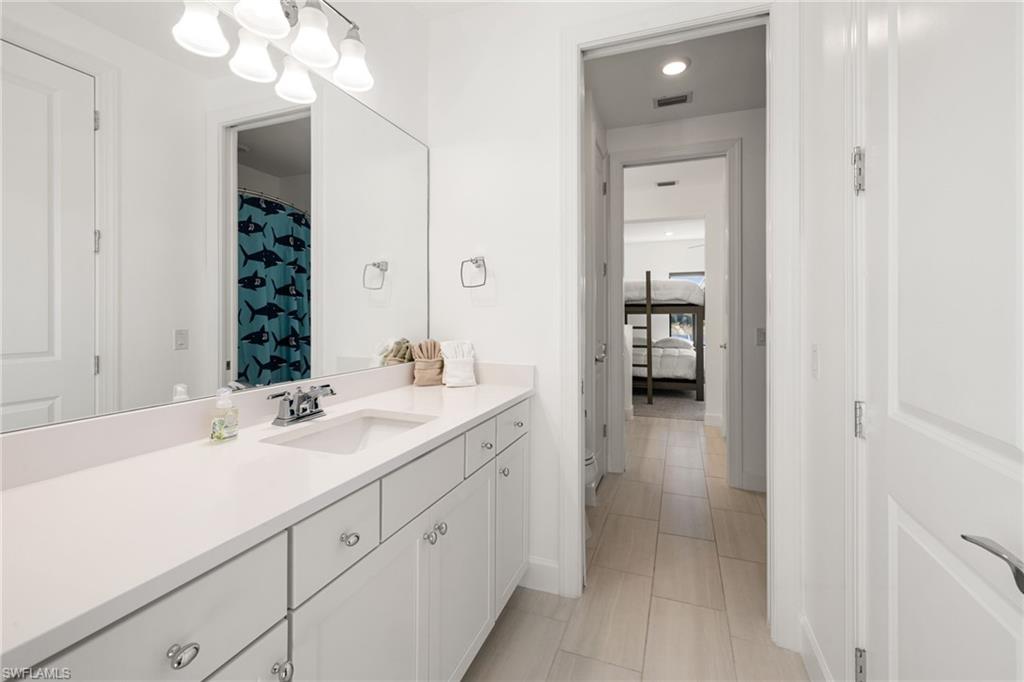 19824 Beverly Park Road Estero, FL 33928 - Photo 32 of 50 a en suite bathroom with a sink and a mirror