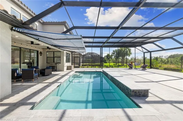 a swimming pool with yard in front of it