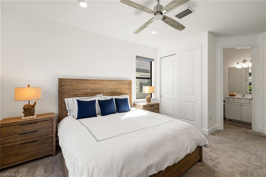 19824 Beverly Park Road Estero, FL 33928 - Photo 6 of 50 a bedroom with a bed and a chandelier