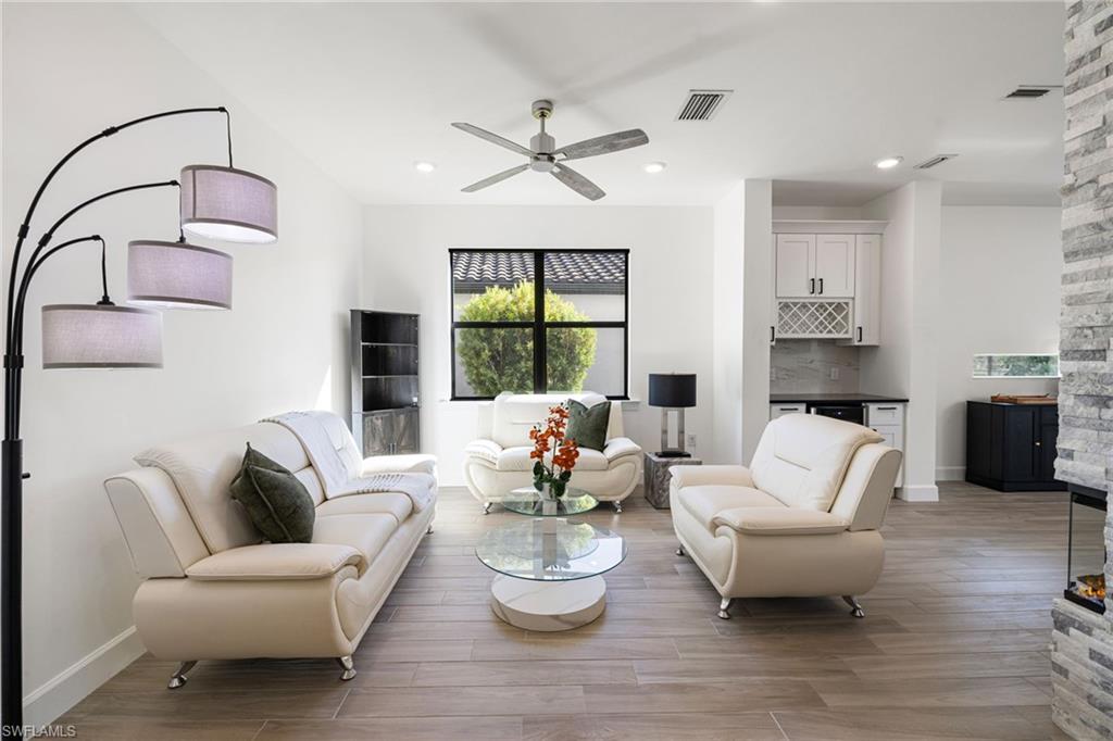 19824 Beverly Park Road Estero, FL 33928 - Photo 7 of 50 a living room with furniture and wooden floor