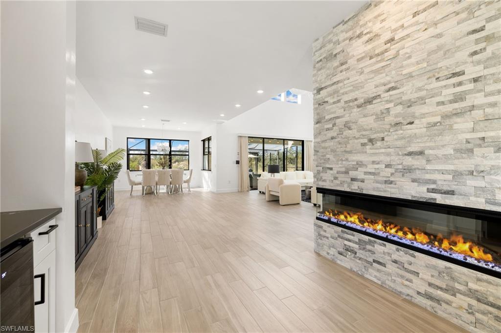 19824 Beverly Park Road Estero, FL 33928 - Photo 8 of 50 a living room with furniture wooden floor and a fireplace