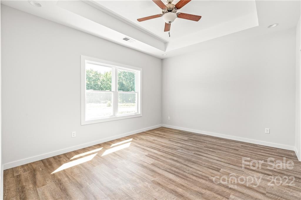 8621 Reedy Creek Road Charlotte, NC 28215 - Photo 15 of 22 an empty room with a window and a ceiling fan