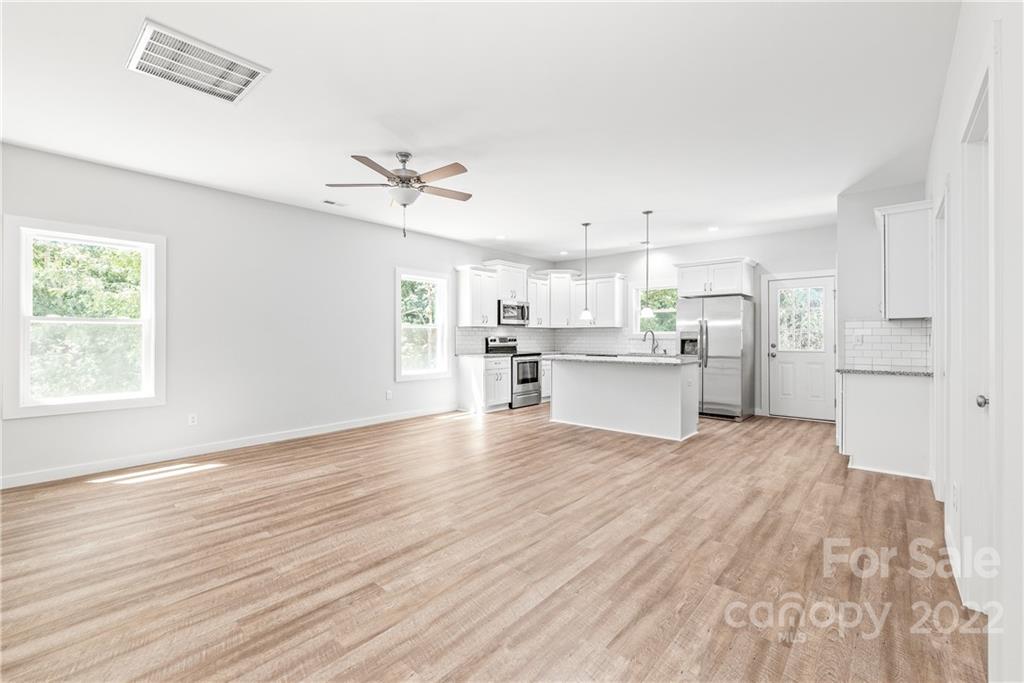 8621 Reedy Creek Road Charlotte, NC 28215 - Photo 17 of 22 a view of a kitchen with wooden floor and a kitchen