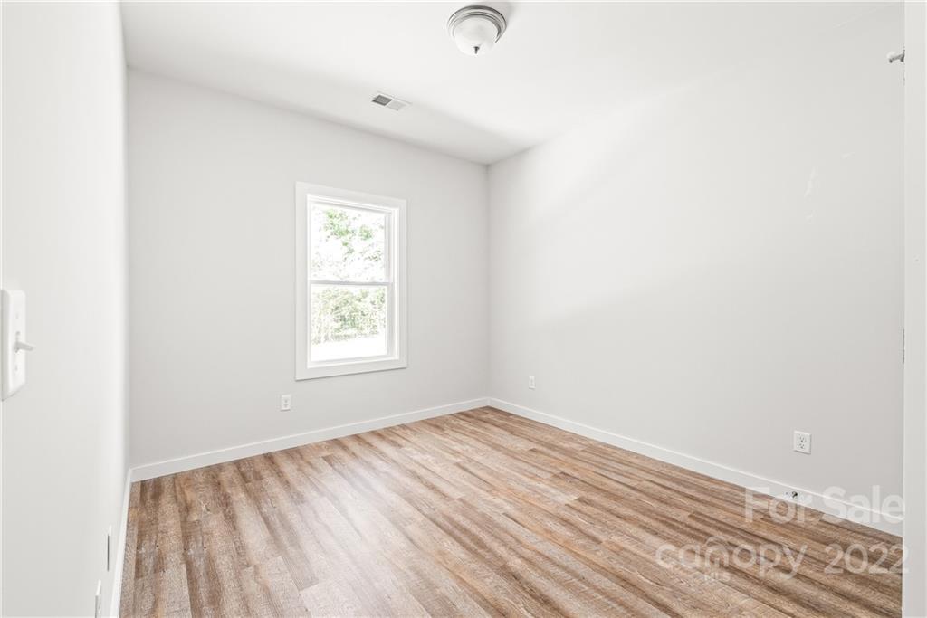 8621 Reedy Creek Road Charlotte, NC 28215 - Photo 19 of 22 a view of room with window and hardwood floor