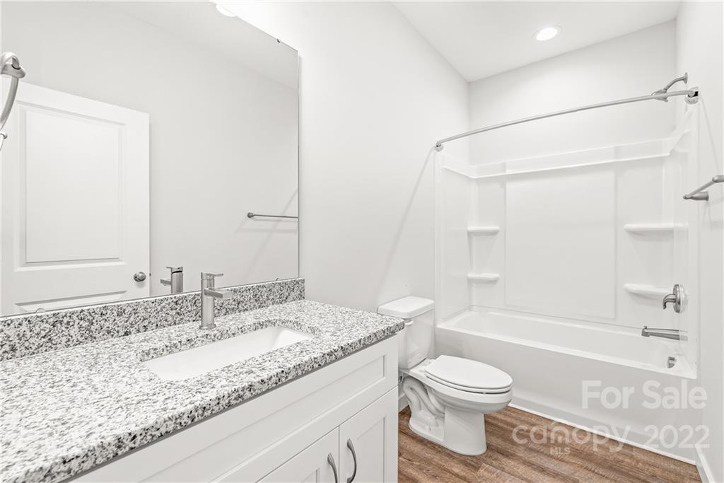8621 Reedy Creek Road Charlotte, NC 28215 - Photo 20 of 22 a bathroom with a granite countertop sink toilet and shower