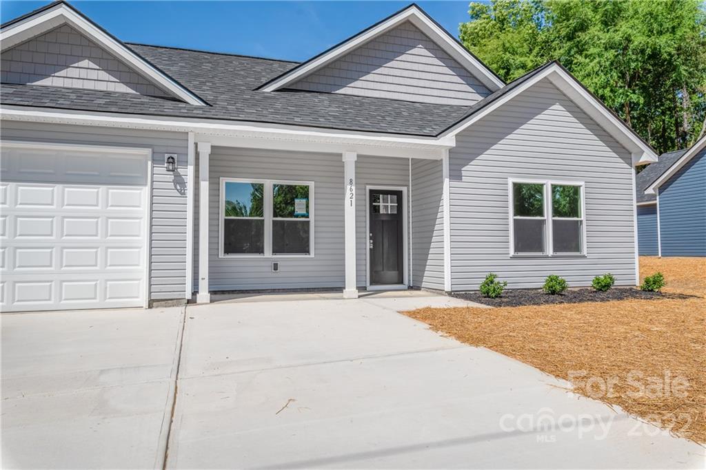 8621 Reedy Creek Road Charlotte, NC 28215 - Photo 2 of 22 a front view of a house with a garage
