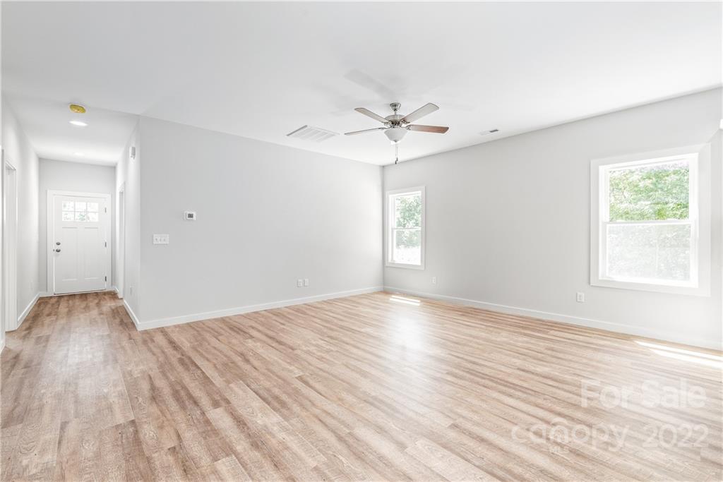 8621 Reedy Creek Road Charlotte, NC 28215 - Photo 21 of 22 a view of empty room with wooden floor and fan