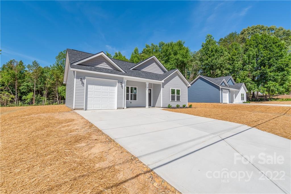 8621 Reedy Creek Road Charlotte, NC 28215 - Photo 3 of 22 a view of house with yard and entertaining space