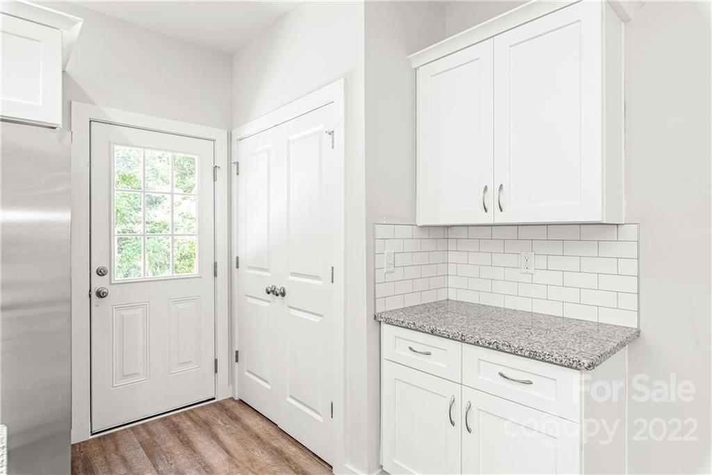 8621 Reedy Creek Road Charlotte, NC 28215 - Photo 10 of 22 a bathroom with a granite countertop sink and a mirror