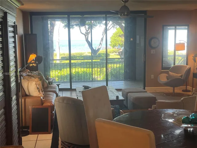 a kitchen with stainless steel appliances granite countertop a refrigerator a stove and a sink with wooden cabinets