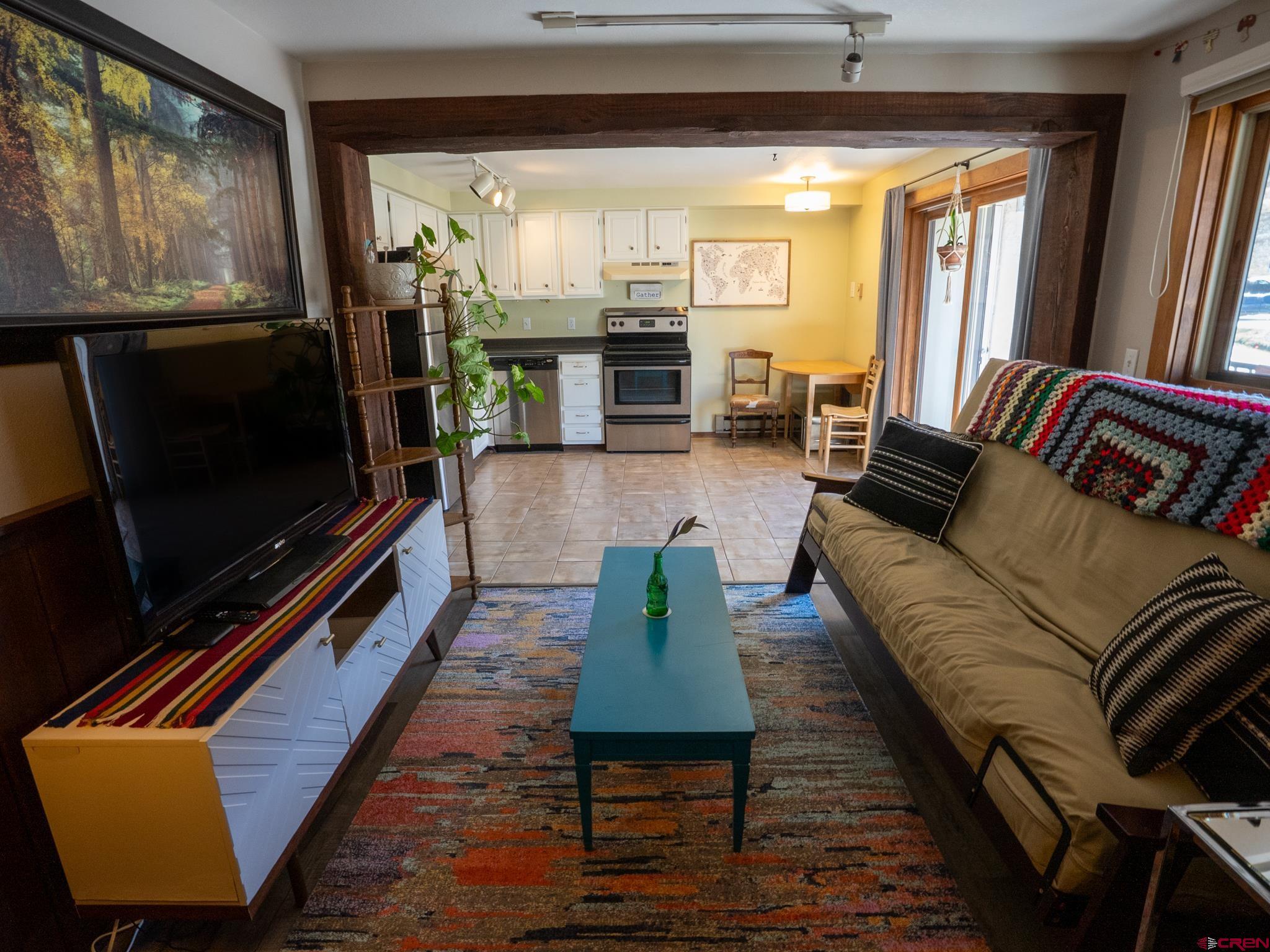 701 Gothic Road, Unit 338 Crested Butte, CO 81225 - Photo 2 of 42 a living room with furniture flat screen tv and a fireplace
