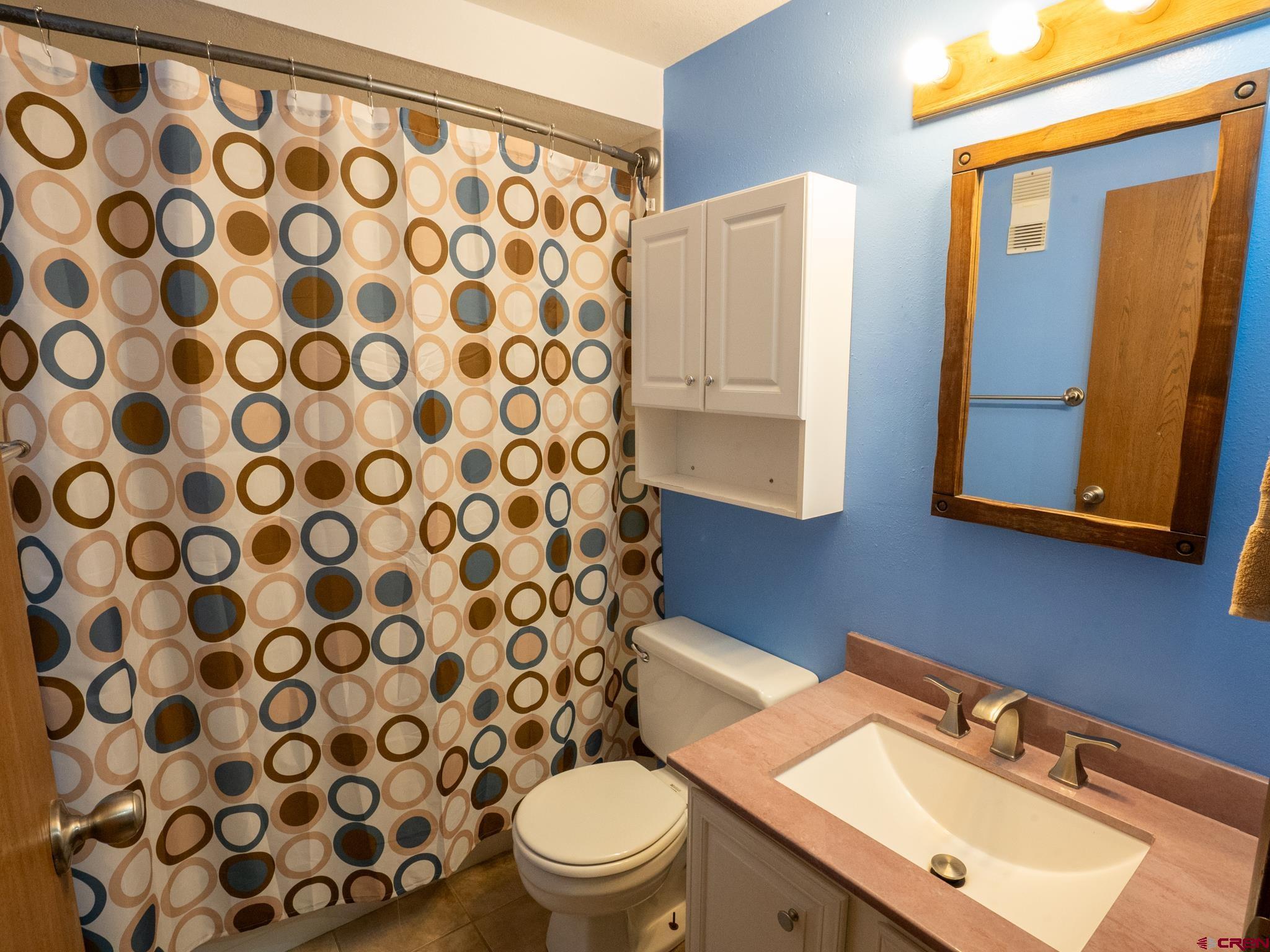 701 Gothic Road, Unit 338 Crested Butte, CO 81225 - Photo 23 of 42 a bathroom with a sink toilet and shower