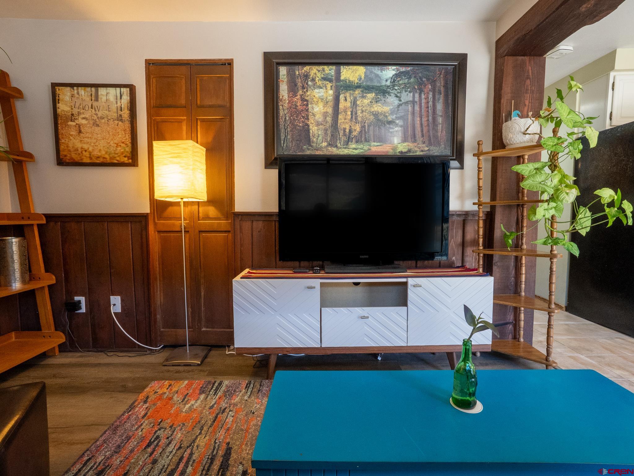 701 Gothic Road, Unit 338 Crested Butte, CO 81225 - Photo 3 of 42 a living room with furniture a flat screen tv and a floor to ceiling window