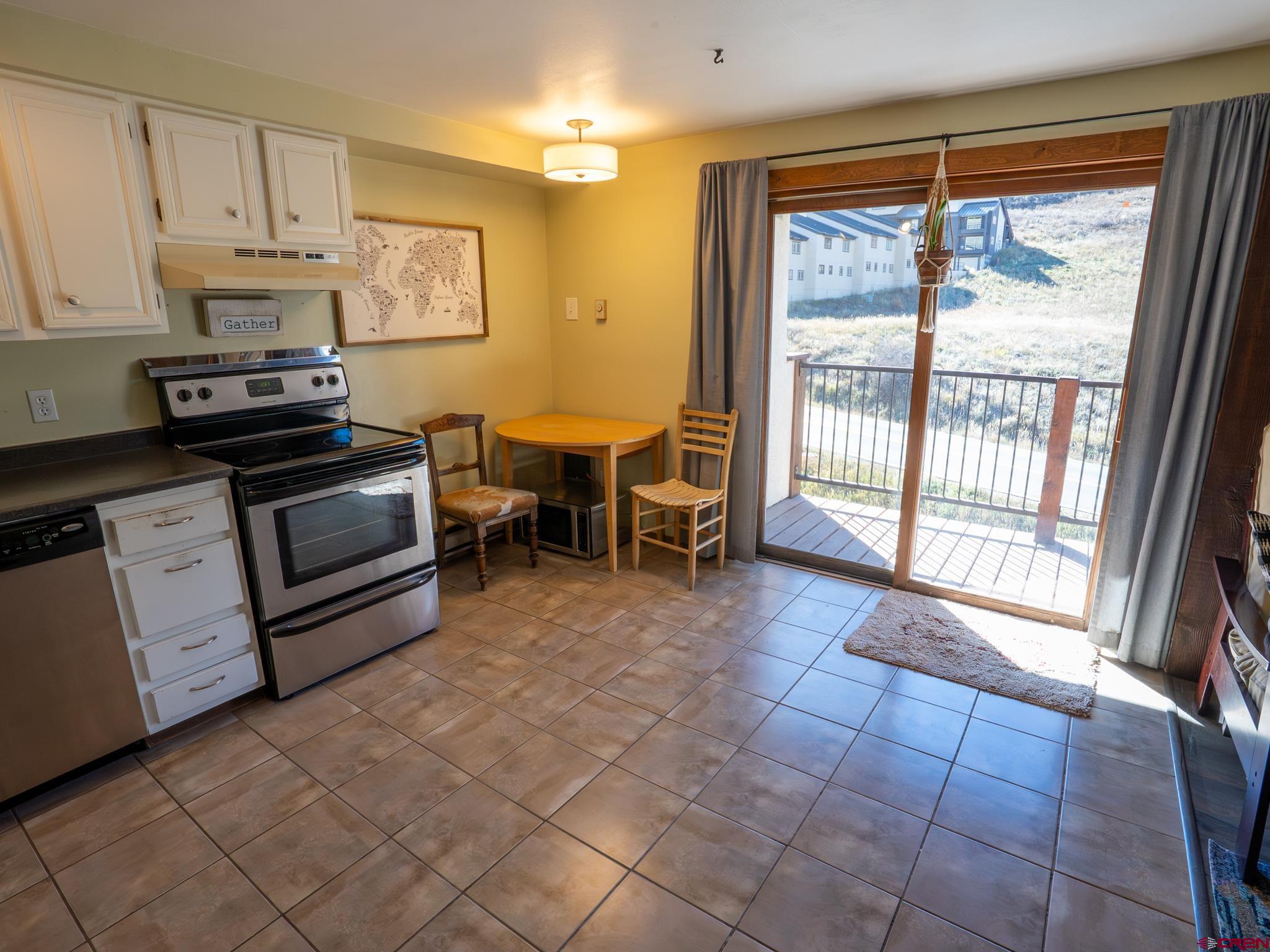 701 Gothic Road, Unit 338 Crested Butte, CO 81225 - Photo 10 of 42 a kitchen with stainless steel appliances granite countertop a stove a sink and a microwave