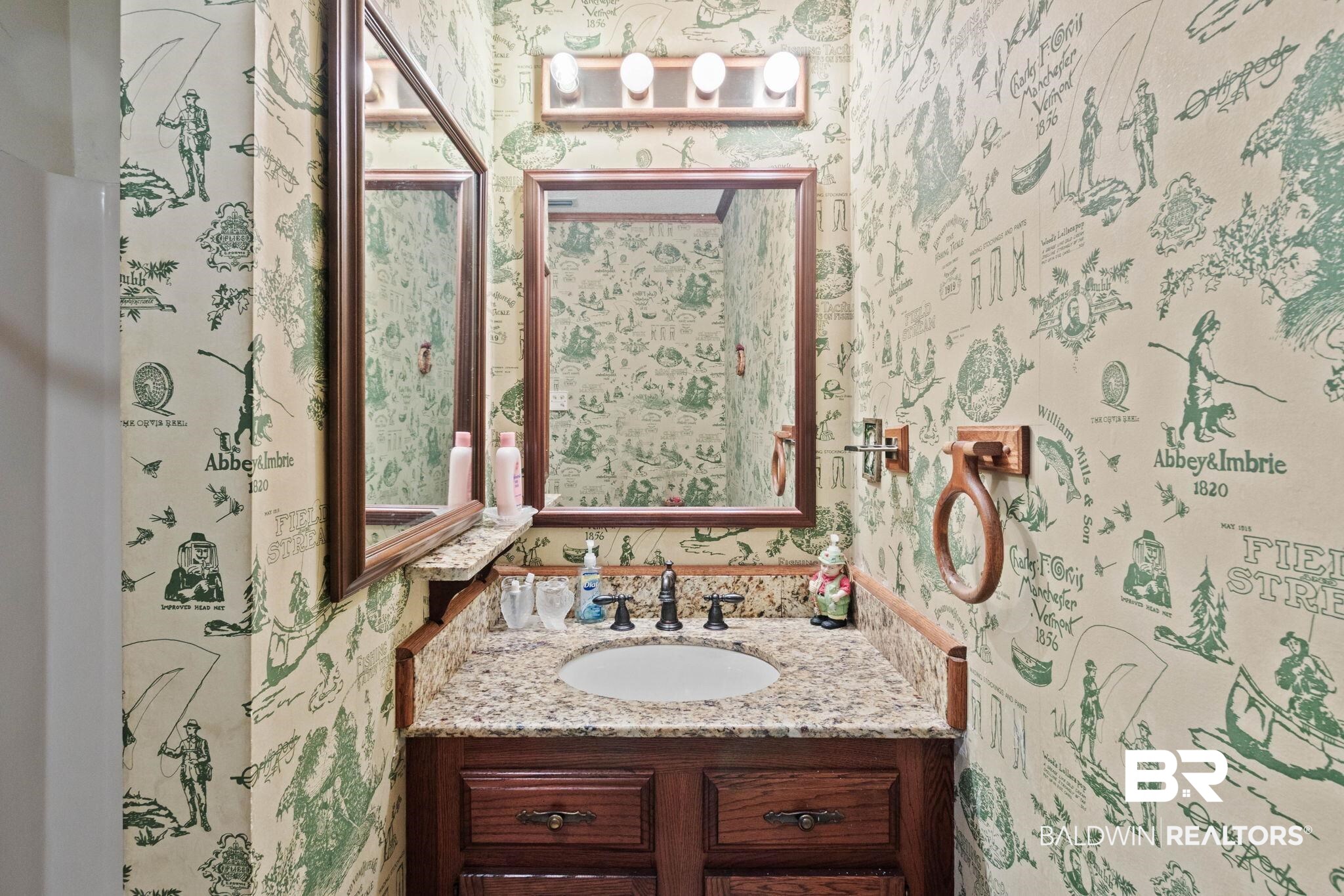 8153 Bryant's Lndg Road Stockton, AL 36579 - Photo 49 of 87 Vanity featuring a granite-style countertop and a white undermount sink